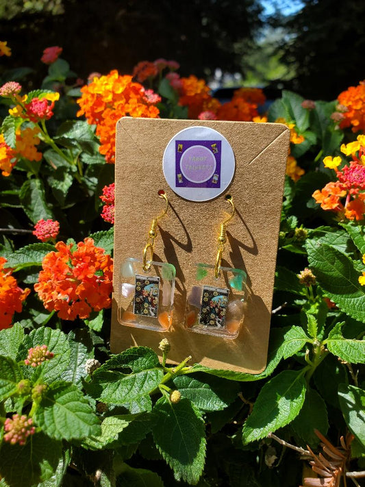 Earrings:  10 OF PENTACLES CARD IN SMALL RESIN SQUARE WITH CATS EYE CRYSTALS/GOLD HARDWARE